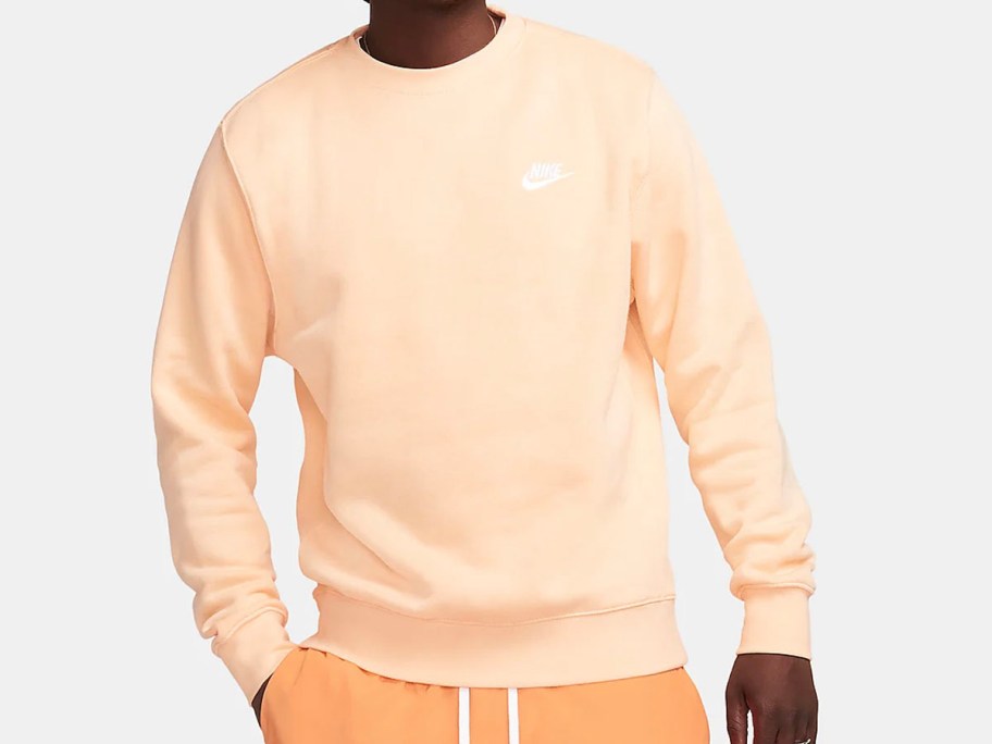 man wearing light orange sweatshirt
