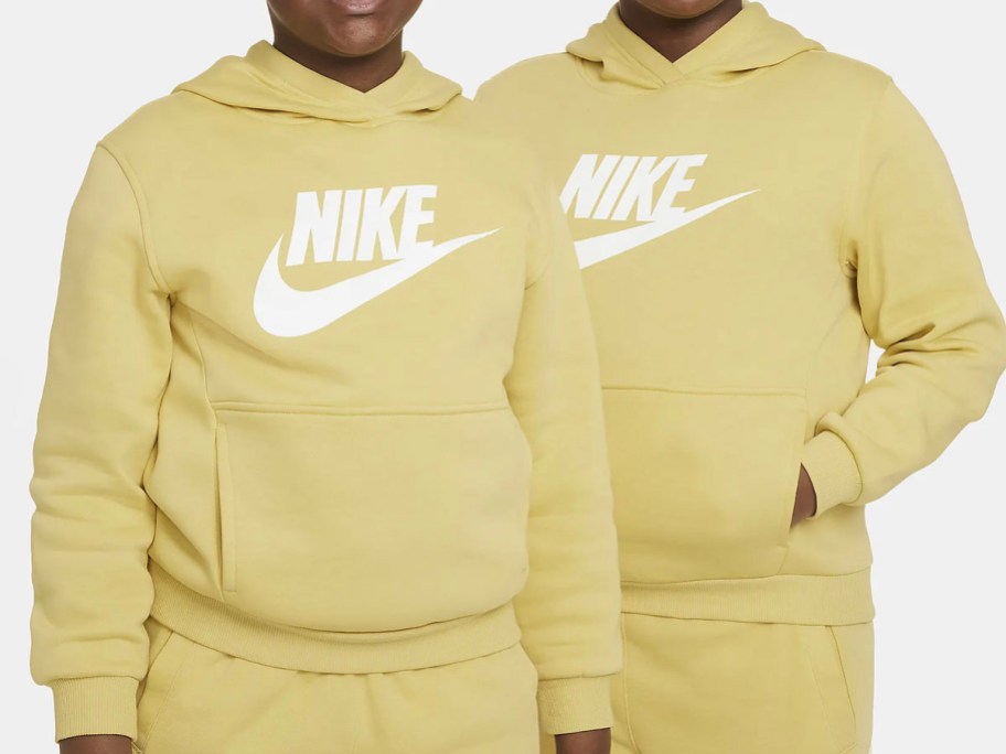 two kids wearing yellow nike hoodies