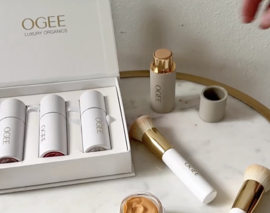 ogee makeup in box sitting on table with makeup brushes