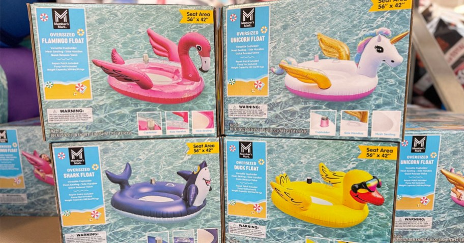 flamingo, unicorn, shark, and duck pool floats stacked in boxes in store