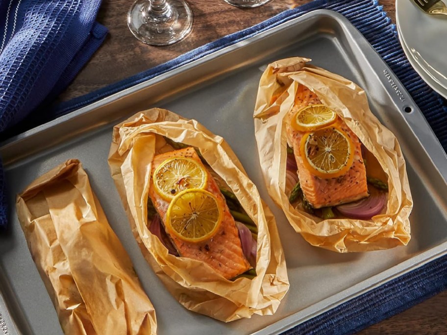 parchment paper surrounding salmon with lemon slices