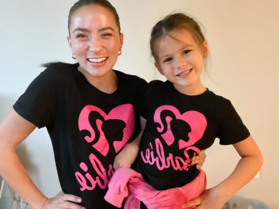 mom and daughter wearing matching black barbie t shirts