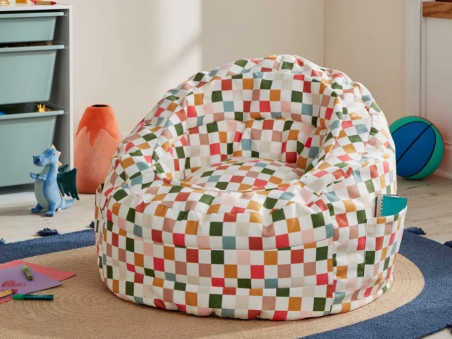 yellow, blue and red checkered bean bag chair sitting in bedroom 