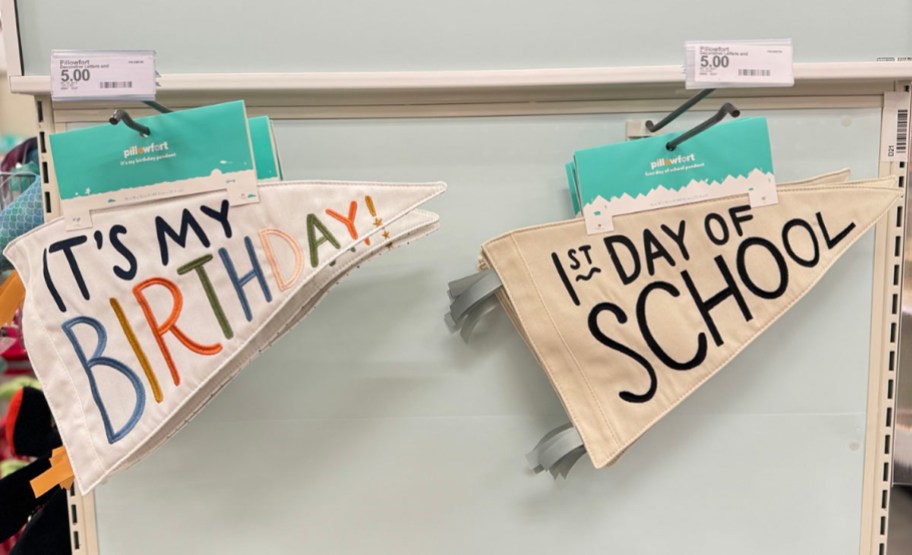 birthday and 1st day of school pendants hanging on display in target store