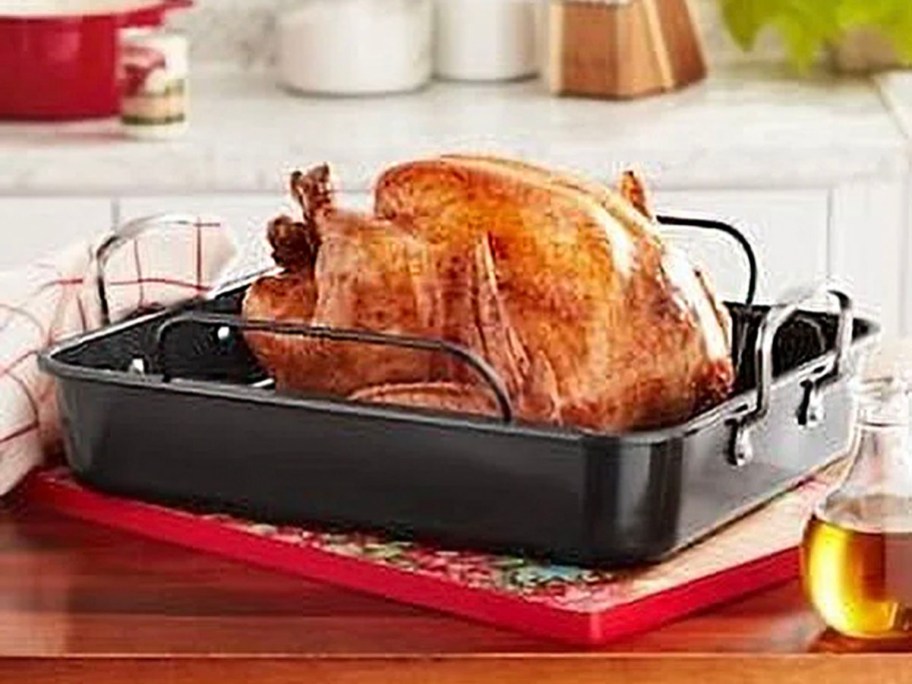 turkey inside roasting pan on kitchen table