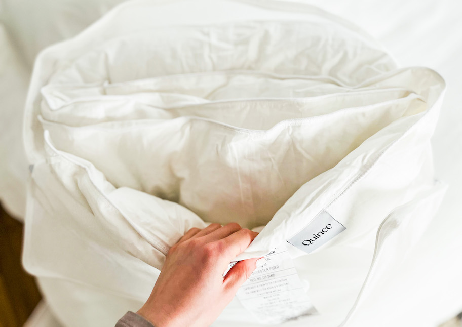 hand holding side of down alternative comforter