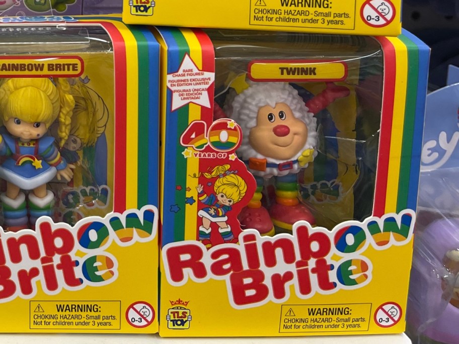 hand holding a box with a Rainbow Brite Twink Mini Doll Figure in it