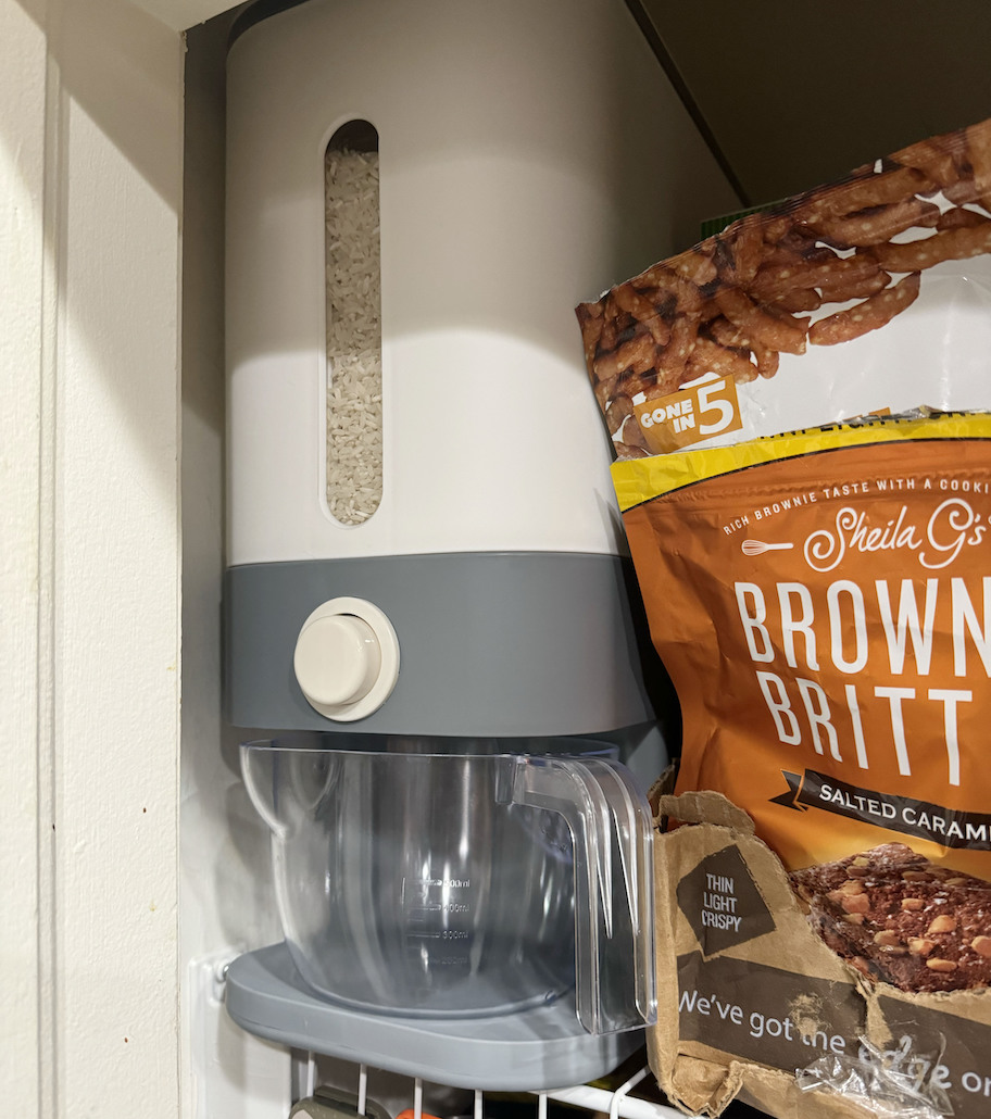 white and gray rice dispenser in corner of pantry