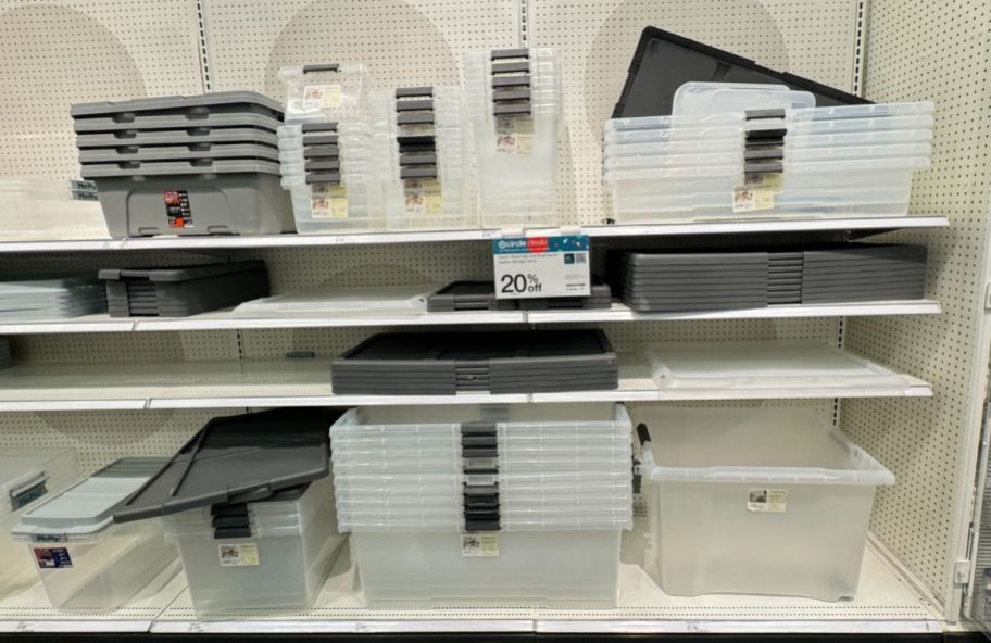 assorted sized storage bins stacked on a store shelf
