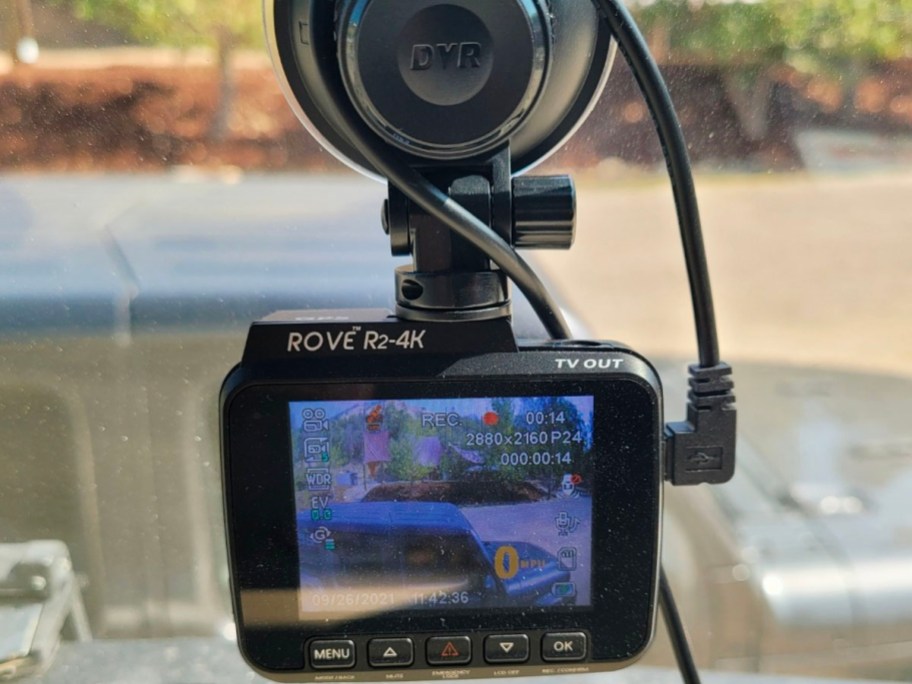 dash cam hanging off of window with image of road on it