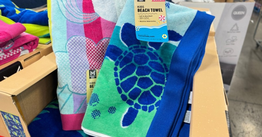 kid's beach towels with turtles and unicorns on display at Sam's Club