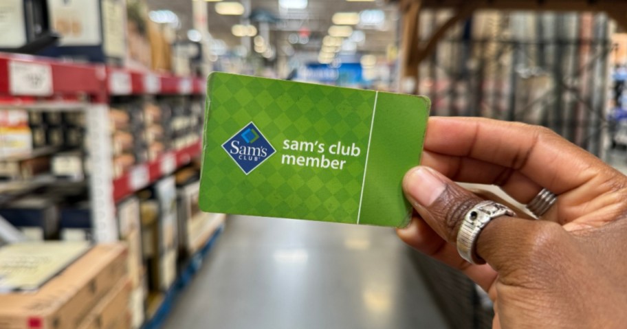 hand holding a Sam's Club Membership card standing in an aisle at Sam's Club