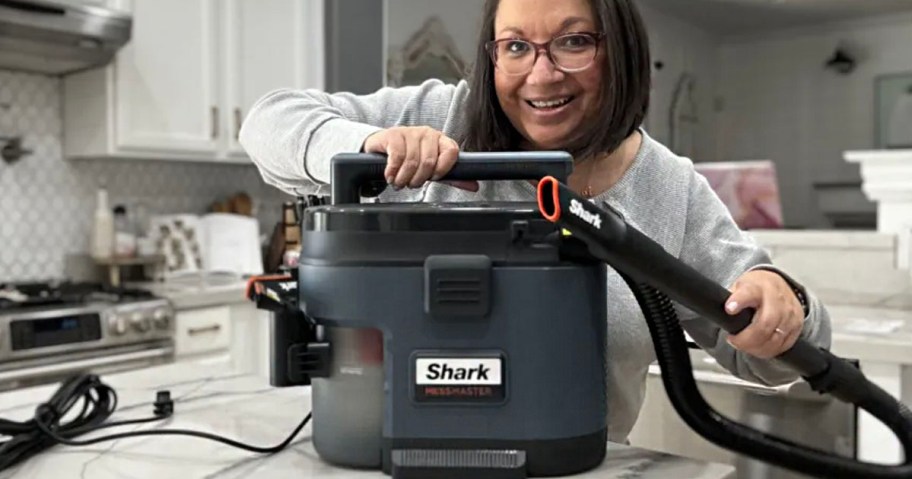 woman with shark mess master on kitchen counter
