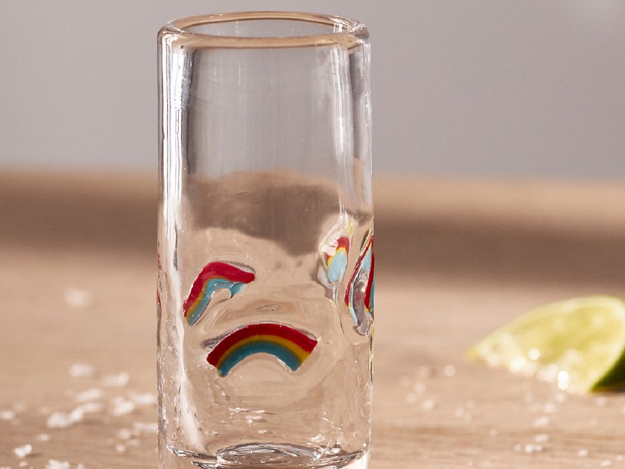 shot glass with rainbows on it and lime slices