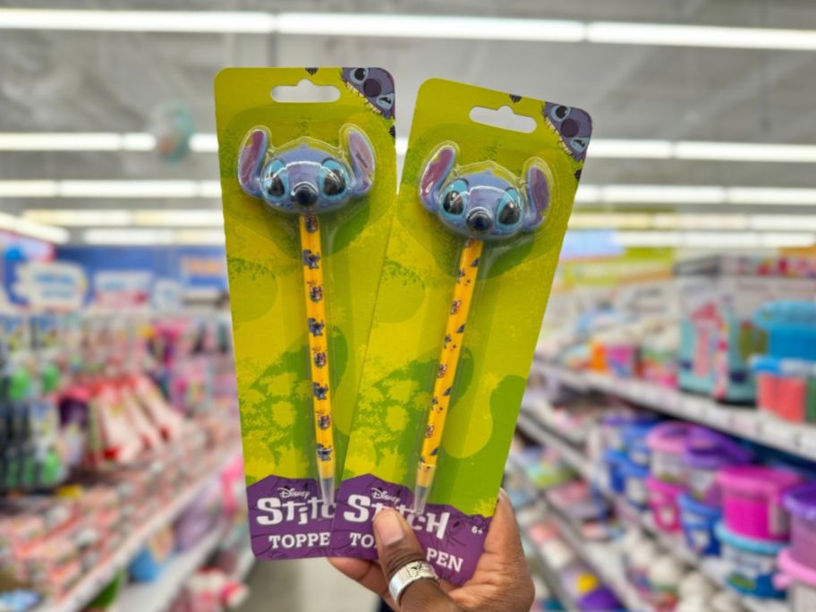 a womans hand holding stitch pencil toppers 
