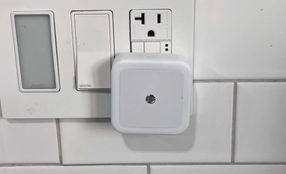 a nightlight plugged in to an electrical receptacle