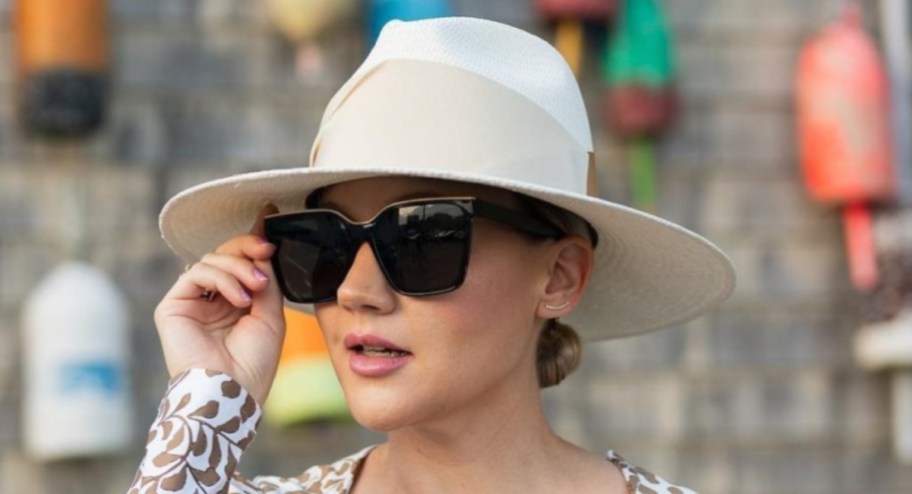 women in white hat and black square frame sunglasses