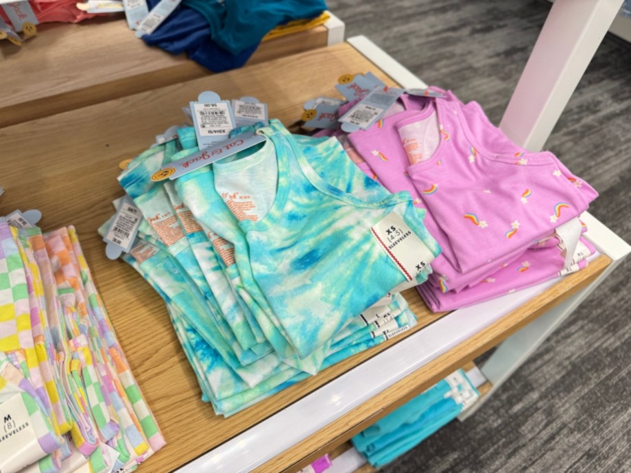 colorful kid's tank tops on a display