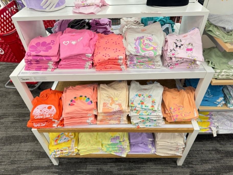 girl's t-shirts in various colors and graphics on display rack in Target