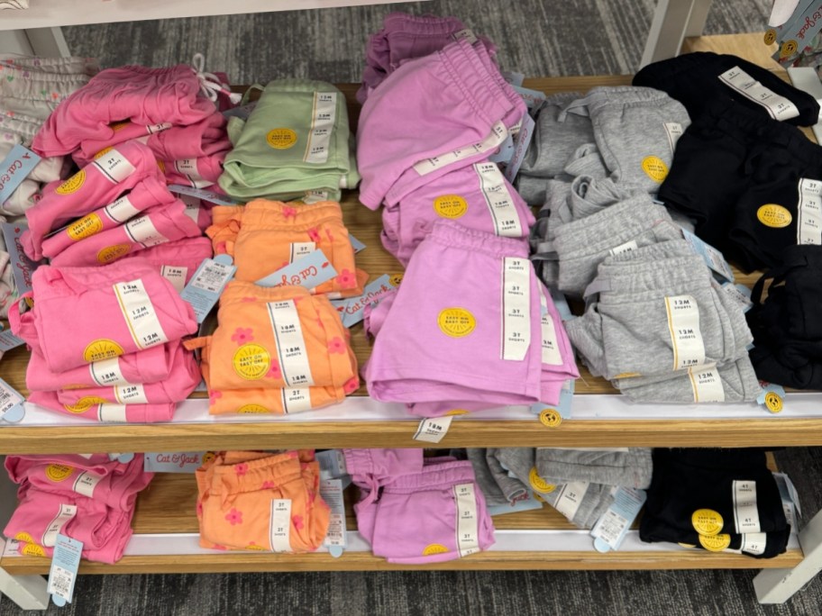 various pairs of girl's shorts in different colors on display table