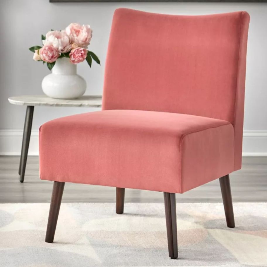 dusty rose color velvet armless side chair in a living room