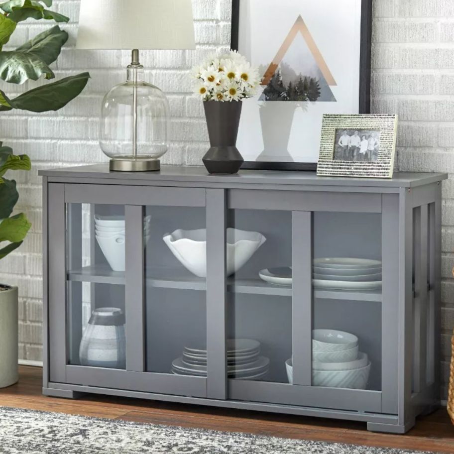 grey console / buffet type table with glass sliding doors 