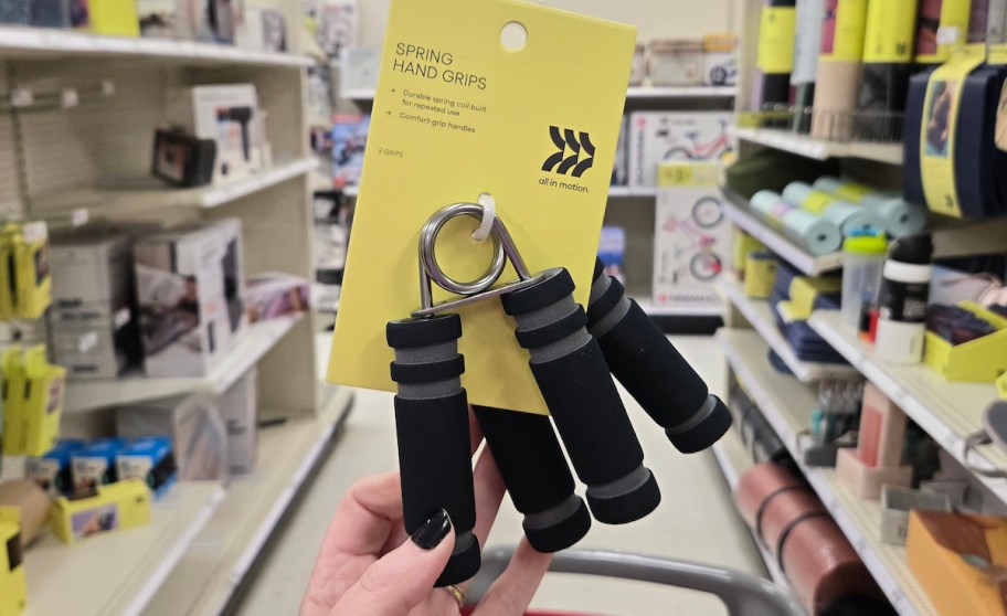 hand holding two hand grips in store aisle