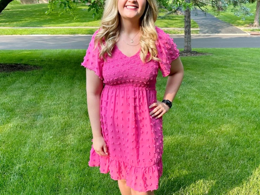 woman wearing hot pink dress in grass