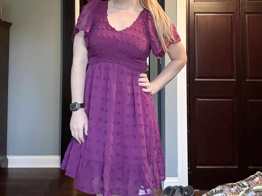 woman wearing purple dress in bedroom