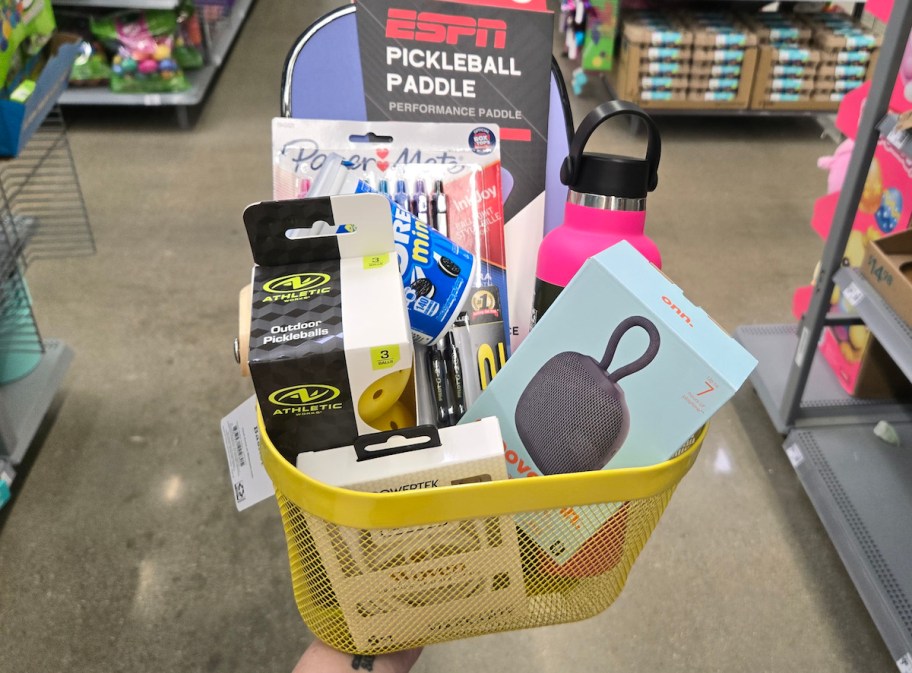 yellow easter basket with toys and tech gear in store aisle 