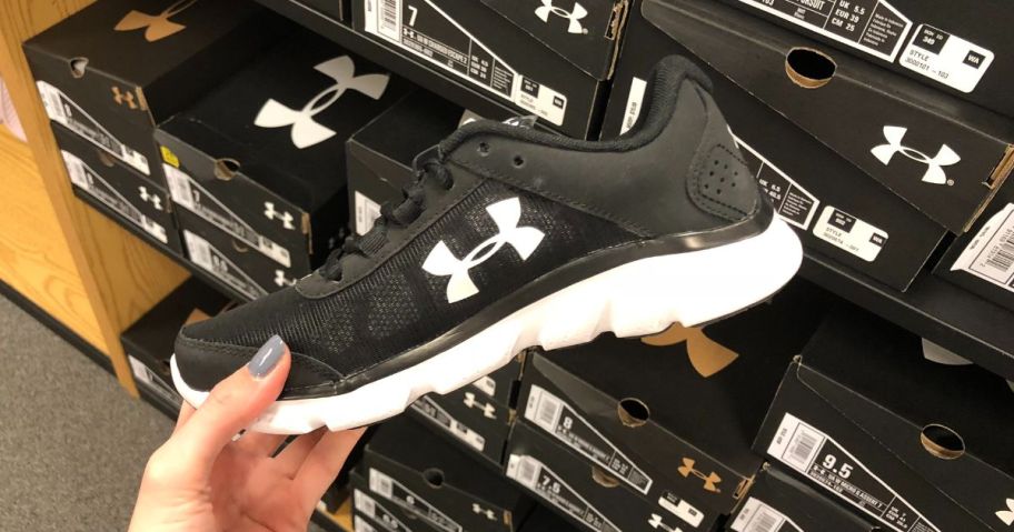 hand holding under armour show in store