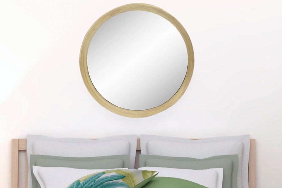 round brown mirror above bed