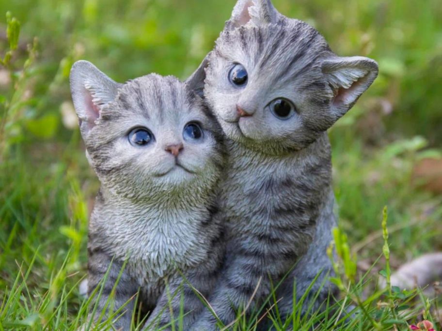 2 kitty statues in yard