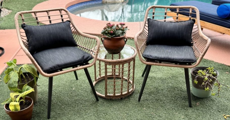 patio set assembled and displayed on a patch of grass in front of a in inground home pool