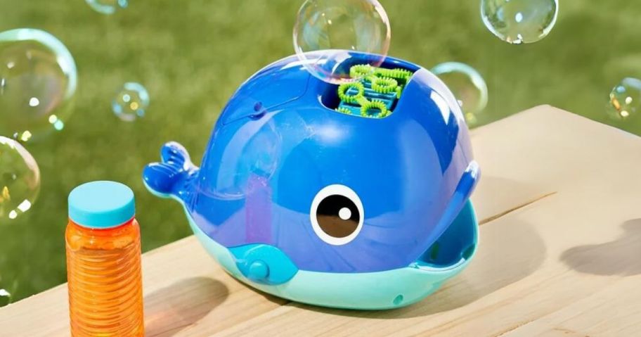 whale shaped bubble blower and bubble solution on a pic nic table