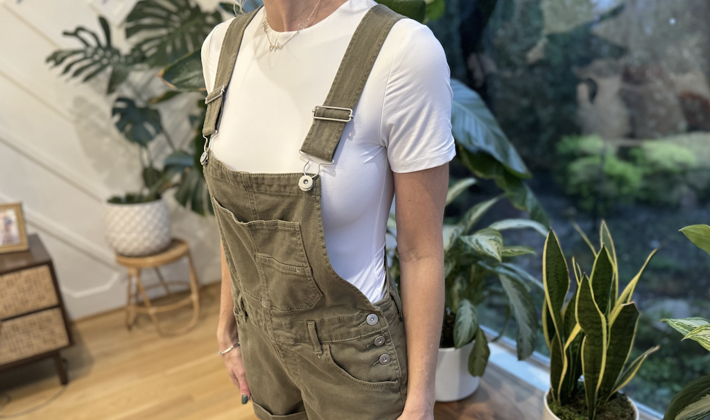 Collin wearing overalls and white bodysuit