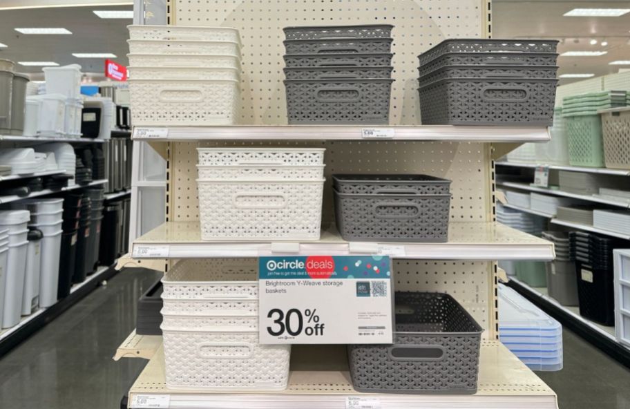 an endcap in a target store stacked with white and gray storage bins