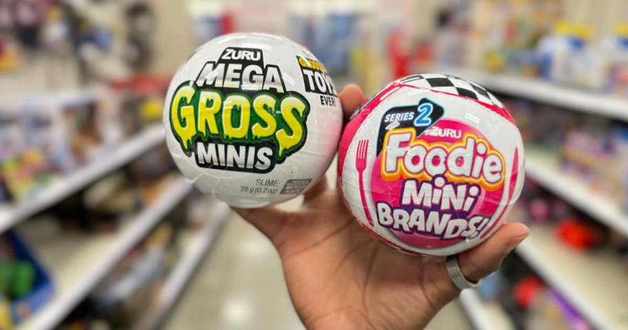 hand holding two zuru mini balls gross and foodie in target store