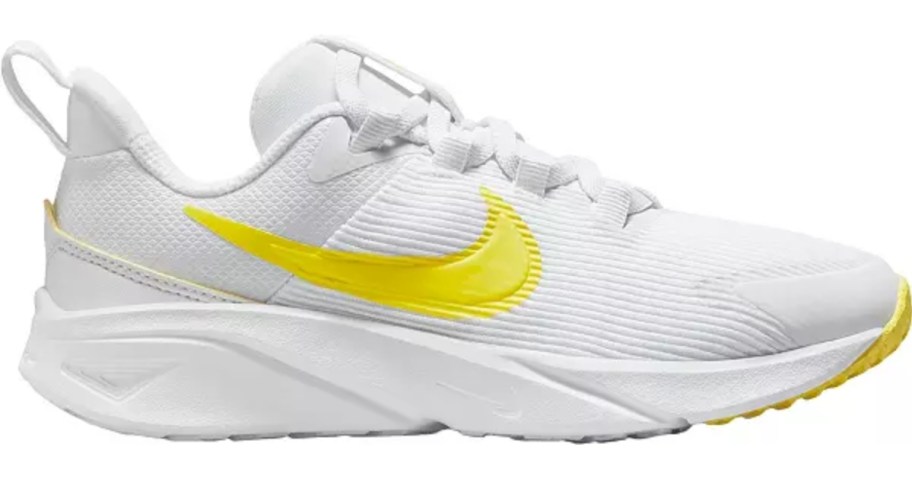white and yellow little kids Nike shoe