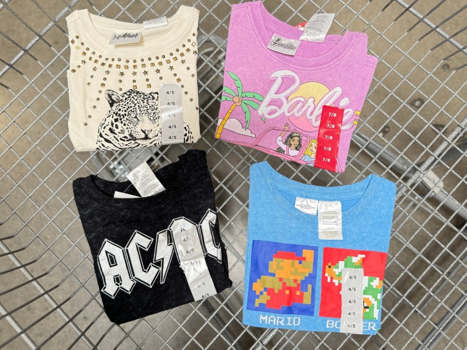 kid's retro tees in a shopping cart with AC/DC, Def Leppard, Barbie and Super Mario Brothers on them