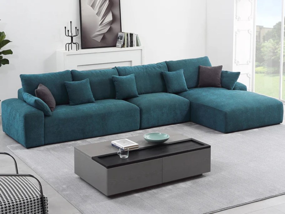 large jade green sectional sofa with chaise lounge end in a living room