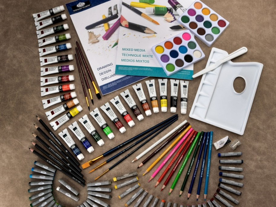 paint, drawing and art set with lots of pieces laying on table