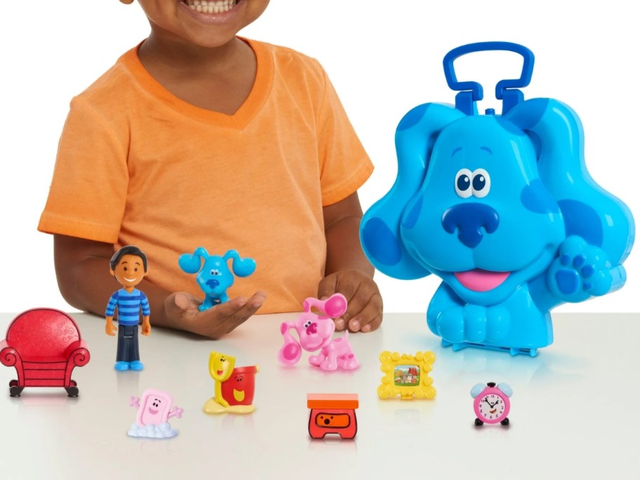 little boy playing with Blues Clues toys with a large Blue dog case 
