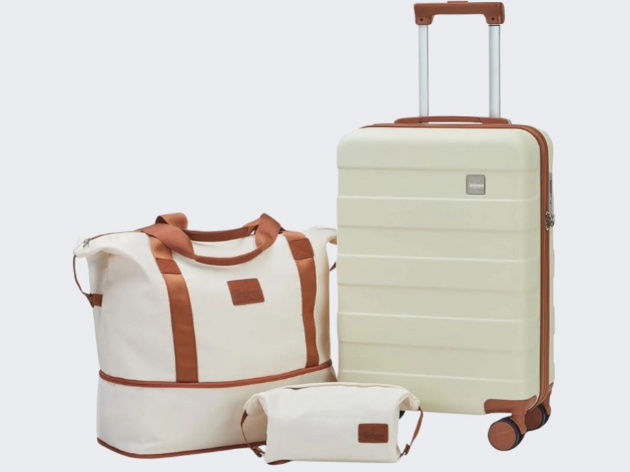 white luggage set with brown details, duffle bag, toiletry bag and hard-sided carry on suitcase