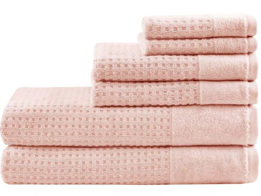 pink waffle style bath towels, hand towels and wash cloths stacked