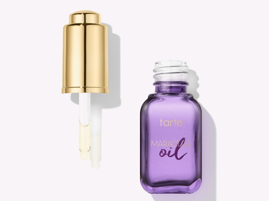 bottle of Tarte Maracuja Oil open with applicator to the side