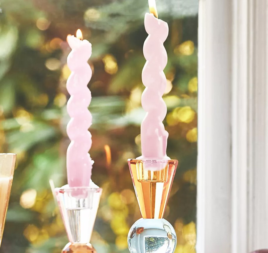 pink spiral taper candles in glass candle holders
