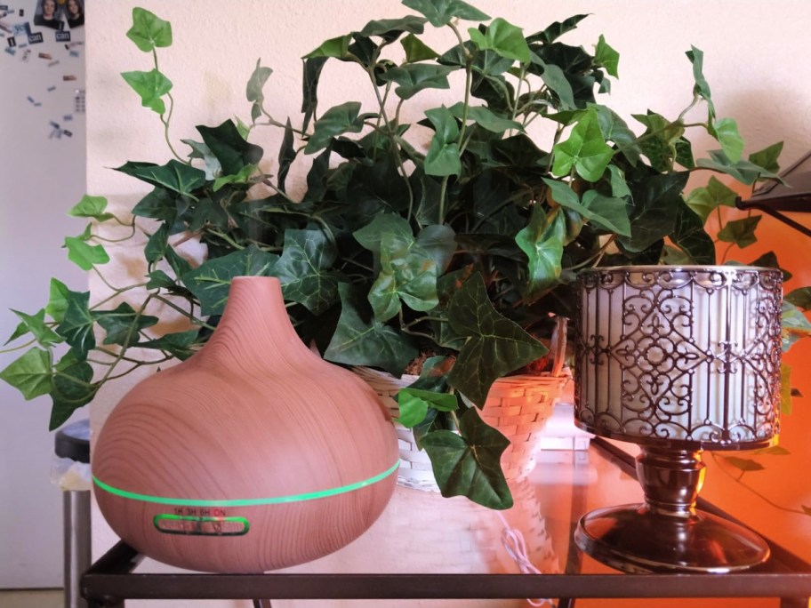 Aromatherapy Diffuser on a table next to a candle holder