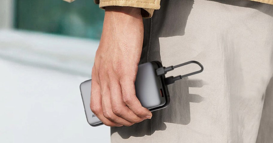 person holding AUKEY power bank in their hand