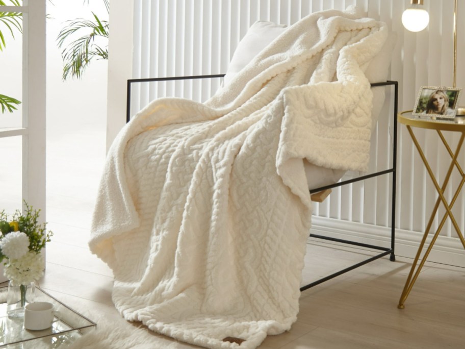 Beige throw blanket faux teddy displayed on a chair
